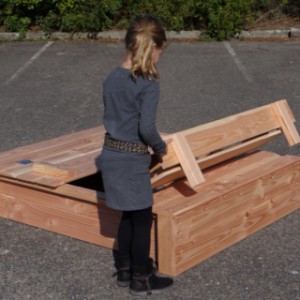 The sandbox lid is easy to fold up, creating two benches inside the sandbox.