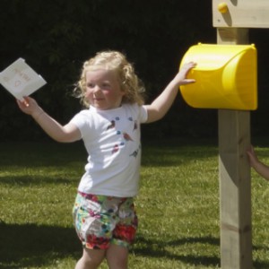 The yellow letter box can easily be mounted on the playhouse