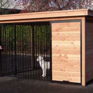 Dog kennel of wood with black pannels