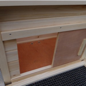 The opening to the sleeping compartment of rabbit hutch Lily can be closed with a sliding door