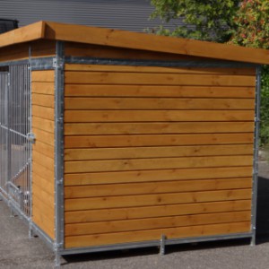 The dog kennel is made of stained pine wood