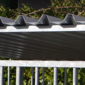 The dog kennel is provided with a roof with corrugated sheets