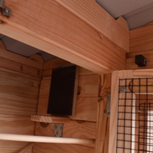 The upper sleeping compartment has a fly hole, the sleeping compartment below has an opening for quails
