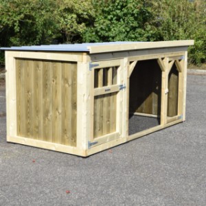 The wooden hutch is provided with a sleeping compartment and a run