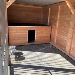 The dog kennel is provided with a sleeping compartment