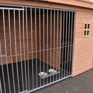 The dog kennel is provided with a feeding system