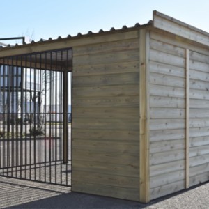 The kennel has a wooden left side