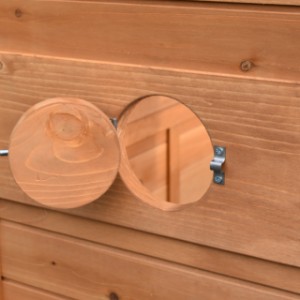 The wooden aviary has a practical fly hole