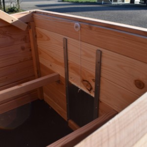 The Chicky 2 chicken coop can be closed using a string attached to the sliding door
