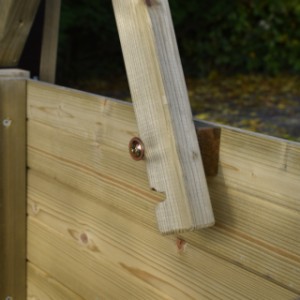 The roof of the chicken coop stays securely open during the deep cleaning.