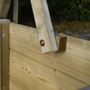 The roof of the chicken coop stays securely open during the deep cleaning.