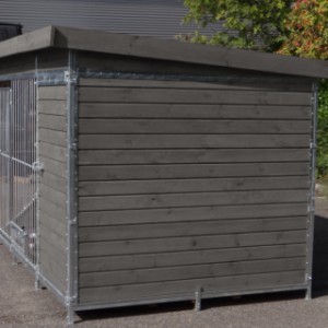 The dog kennel is made of stained pine wood