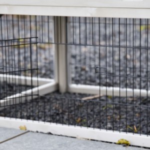 The barred panel beneath the night house of the Prestige Medium has a small door.