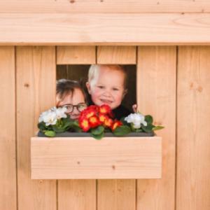 Playhouse Dream features a window with a charming flower box