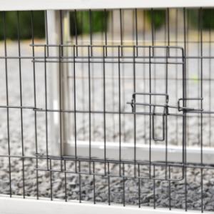 The Prestige Small rabbit hutch is fitted with a small barred door