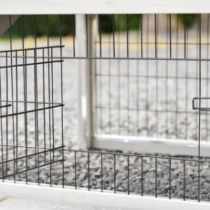 The Prestige Small rabbit hutch is fitted with a small barred door