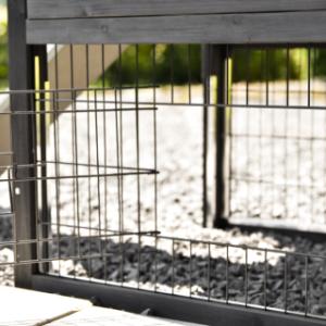 The Prestige Small rabbit hutch is fitted with a small barred door