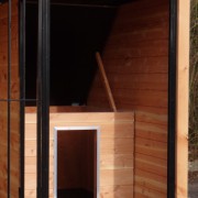 The dog house is provided with a hinged roof